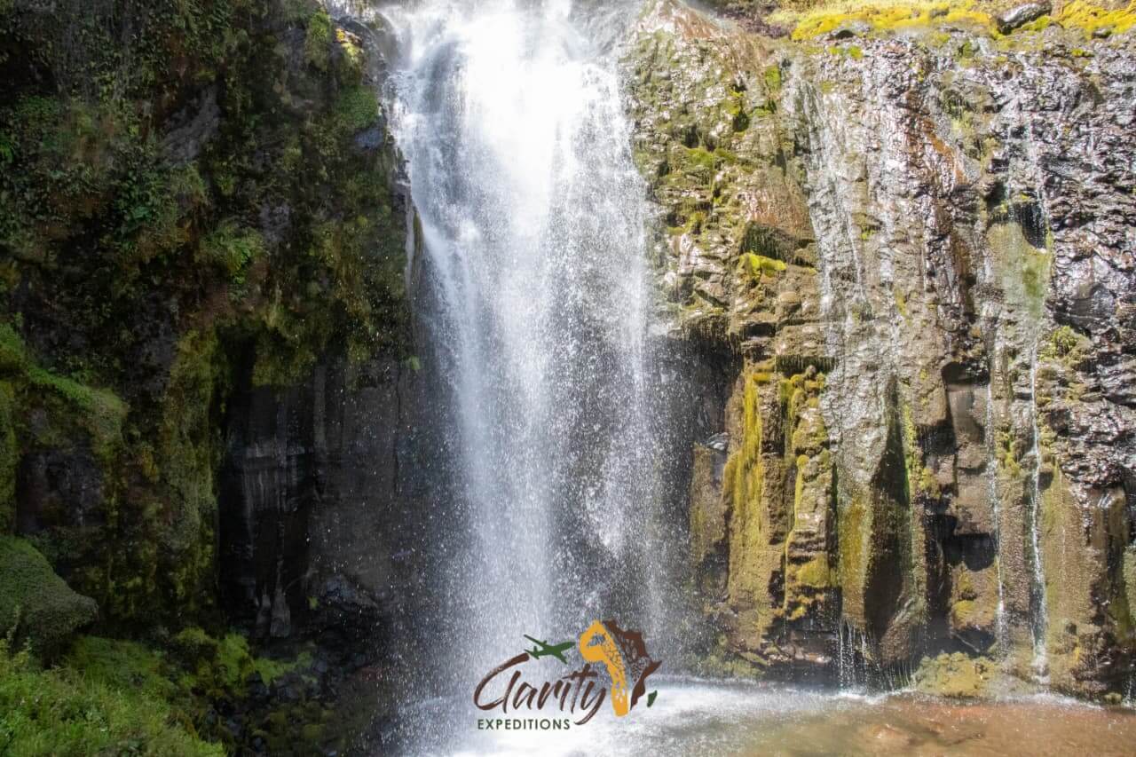A waterfall crashes down volcanic rock