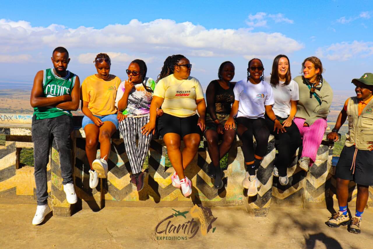 Friends perched above the Rift Valley, soaking in the view